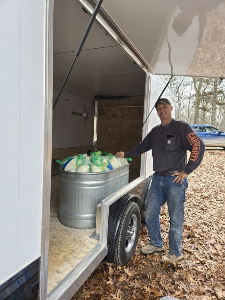 Memory Layne Global Mission - Nathan handing out turkeys